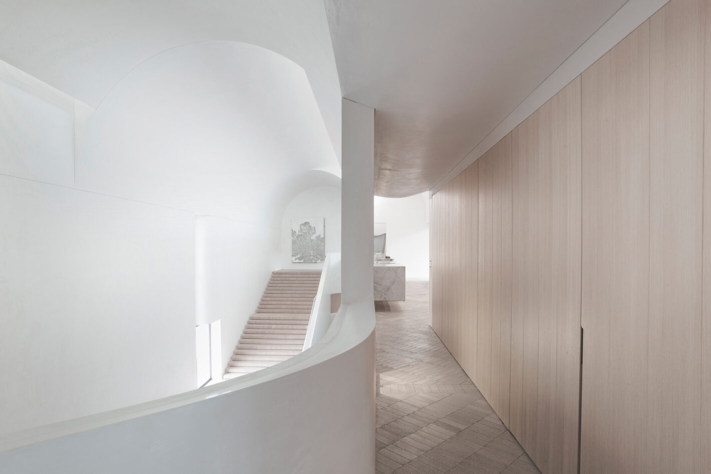 Cavernous stair hall of Indigo Slam, illuminated by concealed roof lights, featuring minimalist design elements and expansive space.