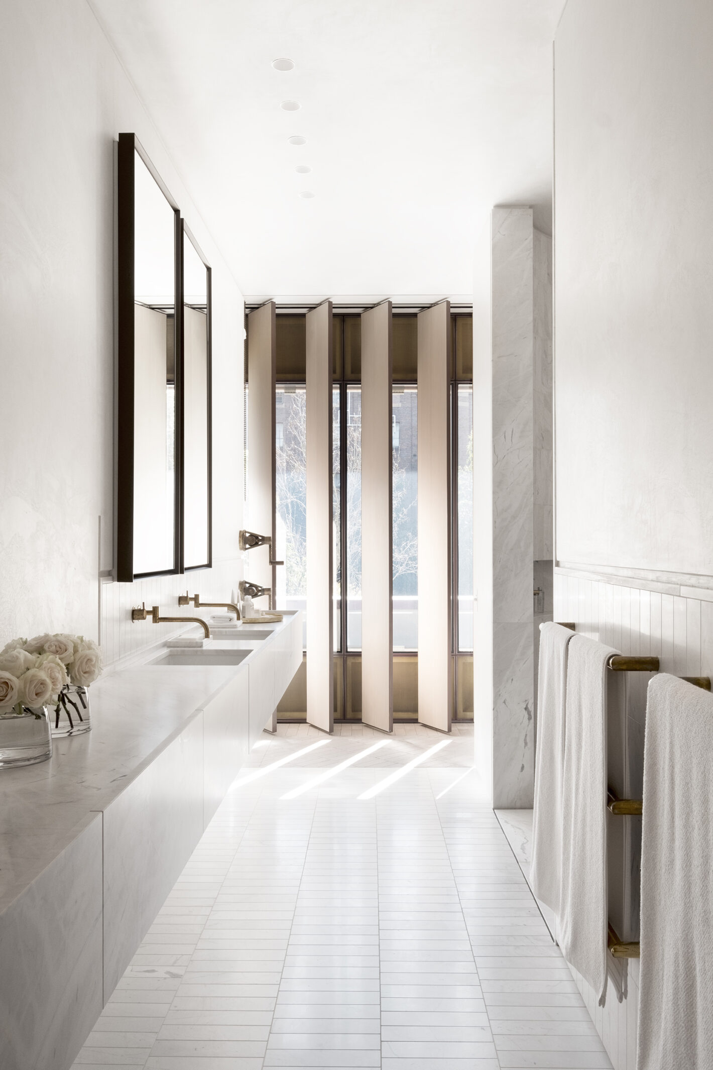 Minimalist bathroom in Indigo Slam featuring pared-back finishes and natural lighting, designed by Smart Design Studio
